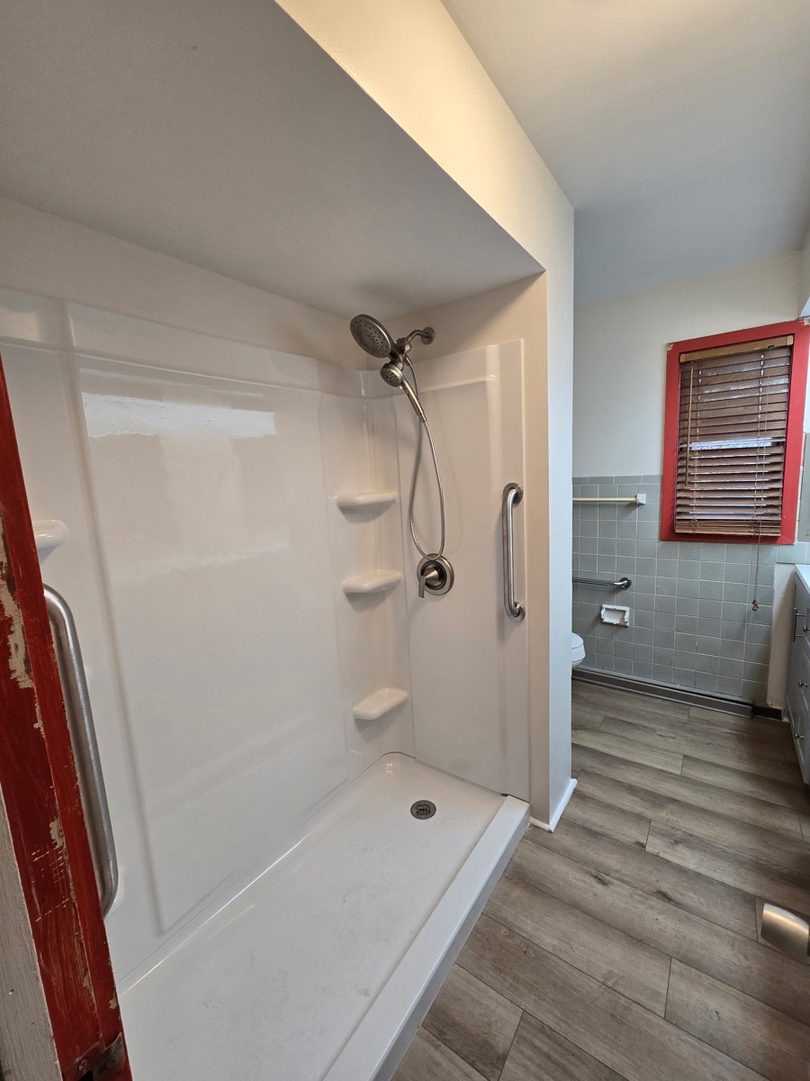 Remodeled bathroom with new vanity, tile and flooring