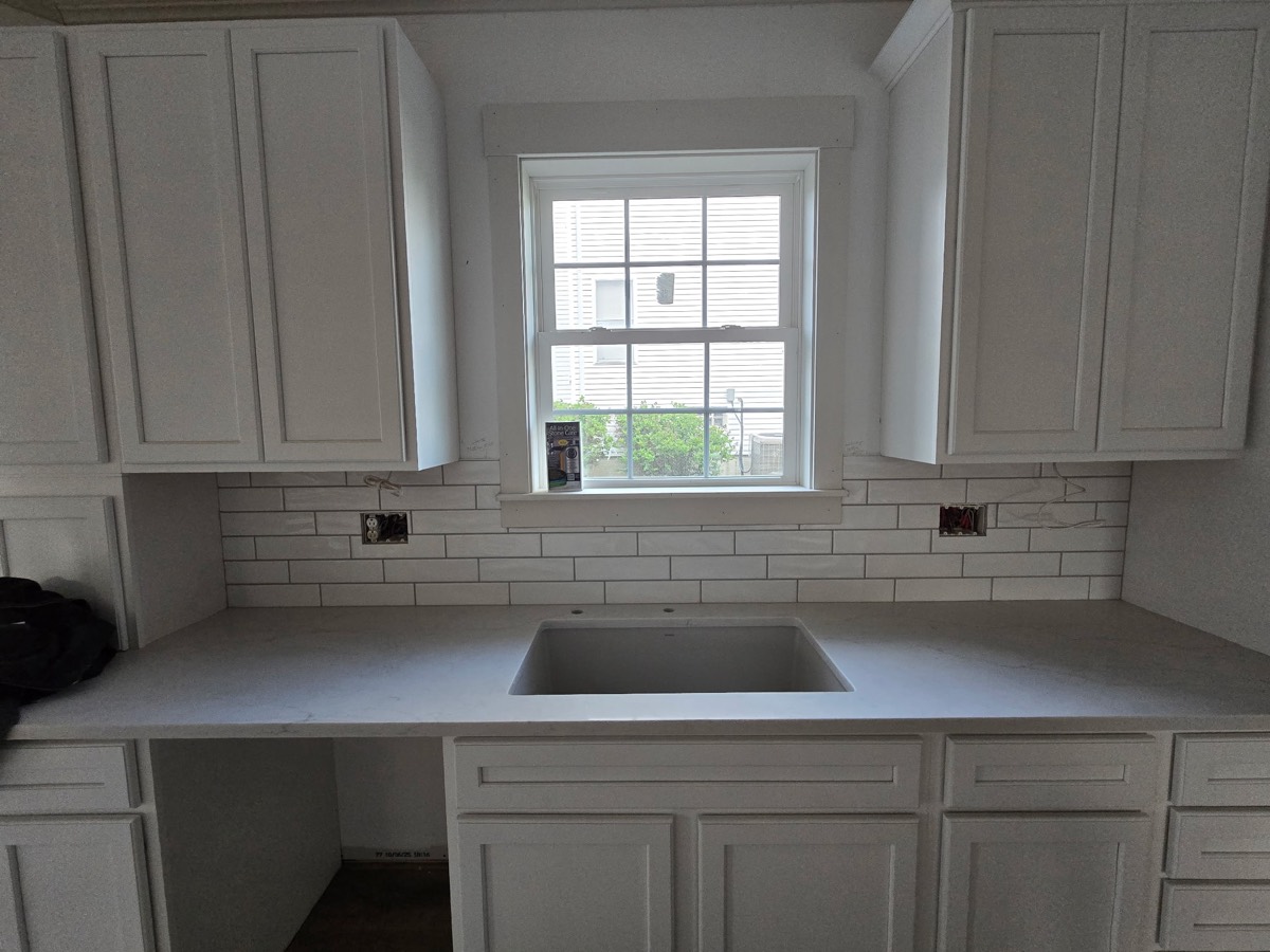 Installed kitchen cabinets and finish work