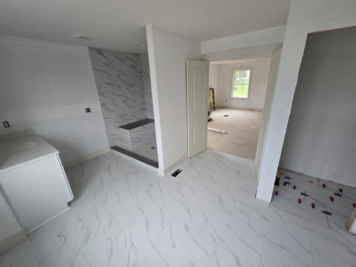 Finished marble-look tile bathroom by JC Luminary Tileworks